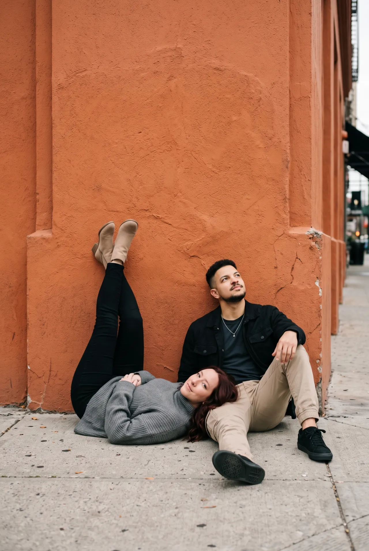 Urban Street – Sitting Together Against an Orange Wall